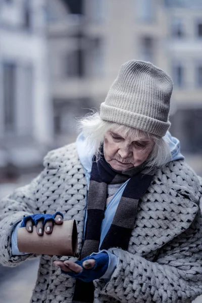 Sad unhappy aged woman checking her money — Stock Photo, Image