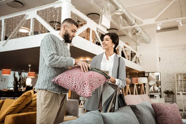 Curious couple comparing colors of materials while choosing furniture — Stock Photo, Image