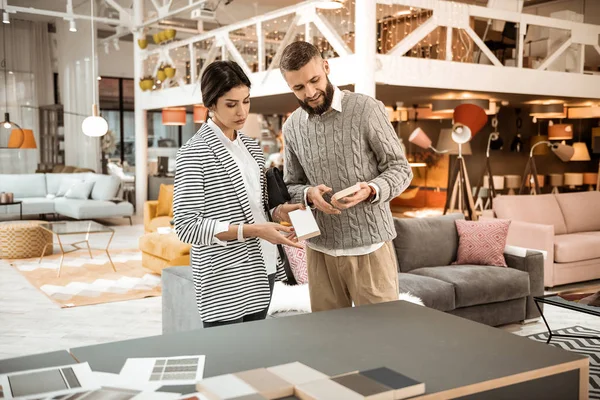 Attentive peaceful couple having conversation about furniture — Stock Photo, Image