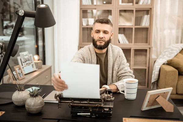 Curious bearded writer checking his writing progress — Stock Photo, Image