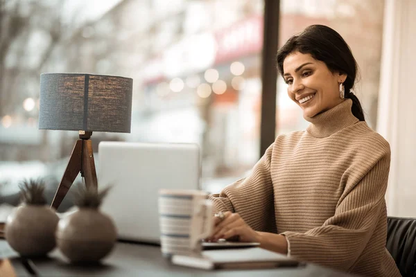 Drukke geconcentreerde knappe vrouw in beige trui — Stockfoto