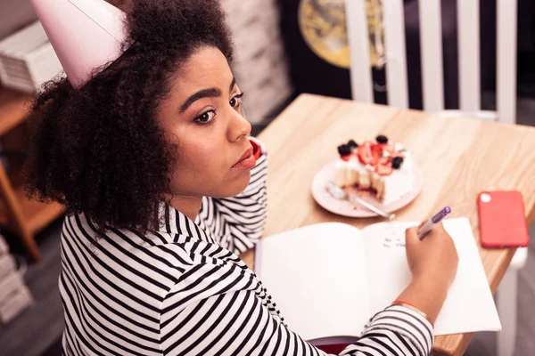 Pleasant thoughtful woman creating plans for her