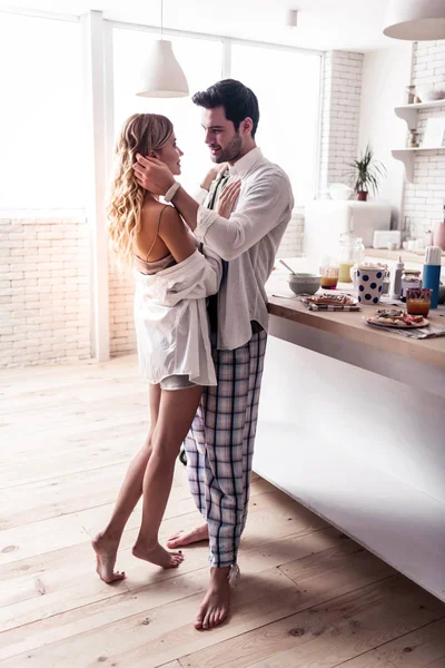 Dark-haired bearded man in a white shirt looking tenderly at his wife — Stock Photo, Image