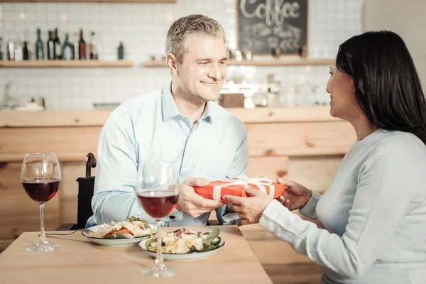 Sorrindo homem apresentando um presente para sua mulher — Fotografia de Stock