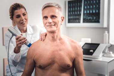 Gri saçlı adam chiropractor tavsiye için geliyor