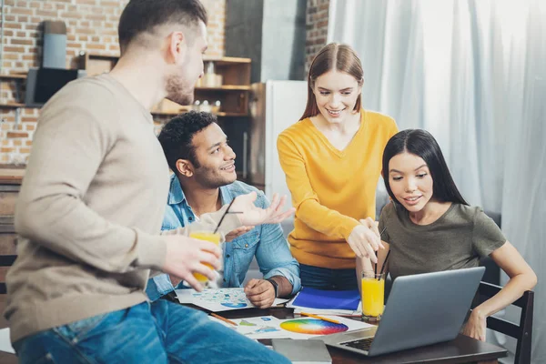 Joyful four colleagues suggesting project — Stock Photo, Image