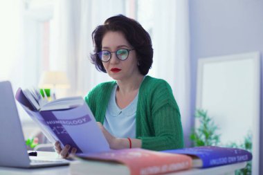 Intelligent good looking woman wearing her glasses clipart