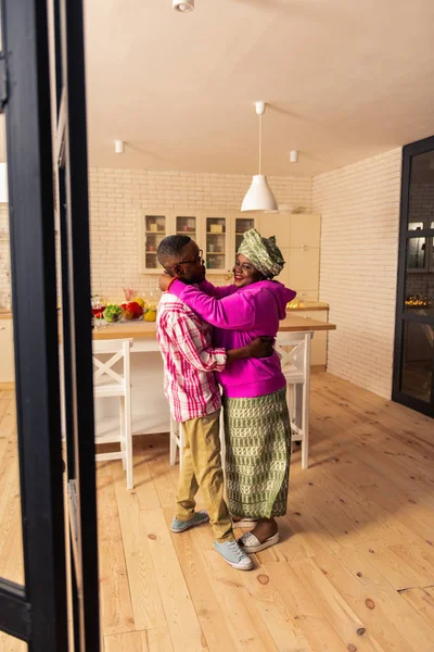 Positive Afro American couple dancing to music