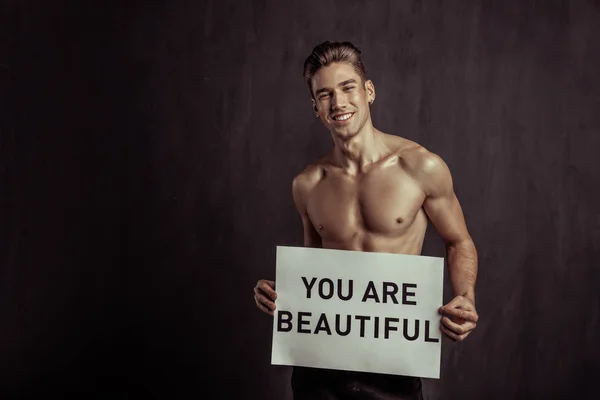 Happy nice man holding a sign with an inscription — Stock Photo, Image