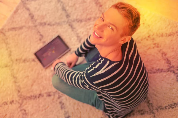 Pleasant joyful guy learning online on tablet — Stock Photo, Image