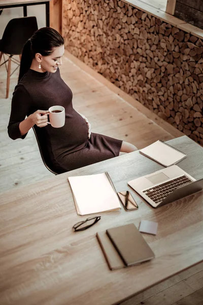 Delighted nice pregnant woman resting from work — Stock Photo, Image