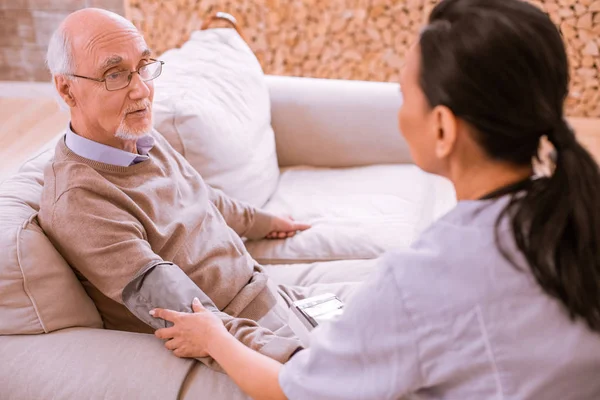 Tired mature man talking to his doctor — Stock Photo, Image