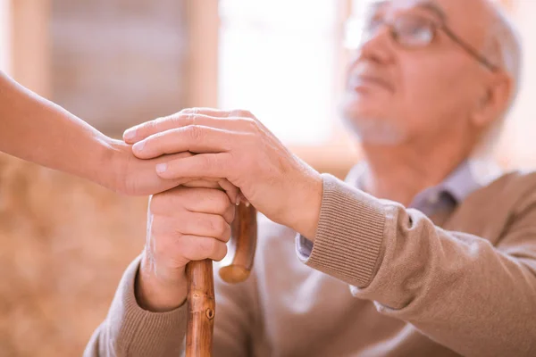 Attentive mature man looking at his volunteer — Stock Photo, Image