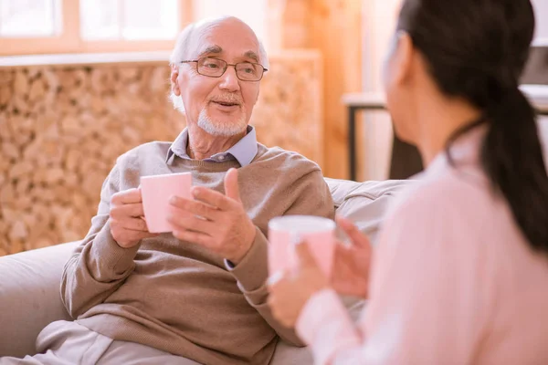 Pleased mature man talking with his nurse — Stock Photo, Image