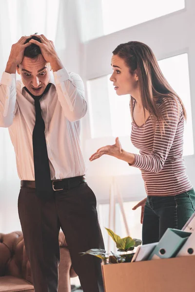 Dismissed man going crazy while listening to his angry wife — Stock Photo, Image