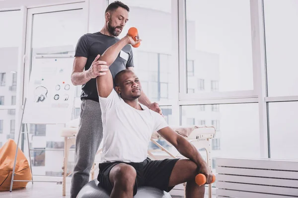 Knappe bebaarde therapeut helpen zijn patiënt tijdens trein — Stockfoto