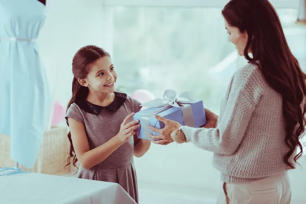 Positive girl making a present for her mother