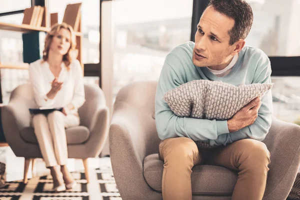 Stressed man feeling terrible visiting therapist