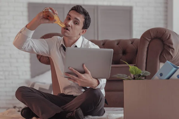 Full längd av arbetslös man dricka öl — Stockfoto