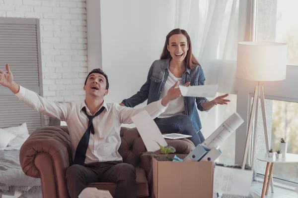 Joyful family throwing documents in the air