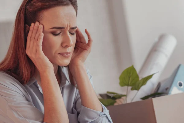 Nahaufnahme einer gestressten Frau, die ihre Schläfen berührt — Stockfoto