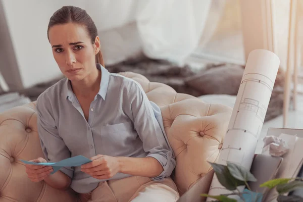 Downhearted woman with unpleasant letter from her boss — Stock Photo, Image