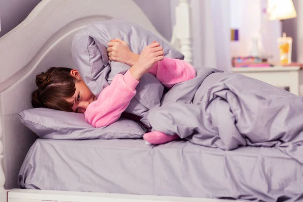 Emotional little female embracing her soft pillow — Stock Photo, Image