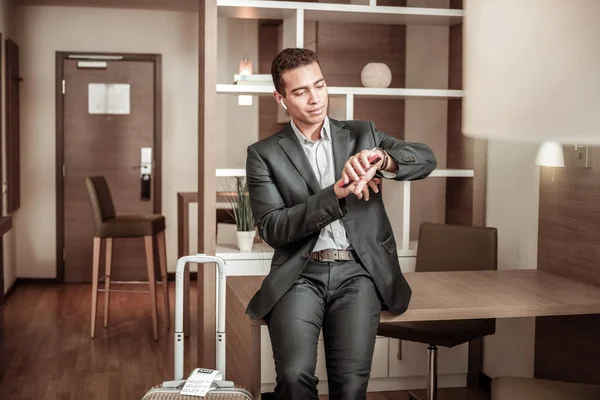 Businessman checking time running late for business meeting