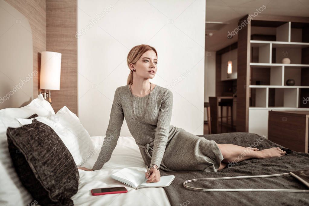 Busy successful woman feeling thoughtful planning her day