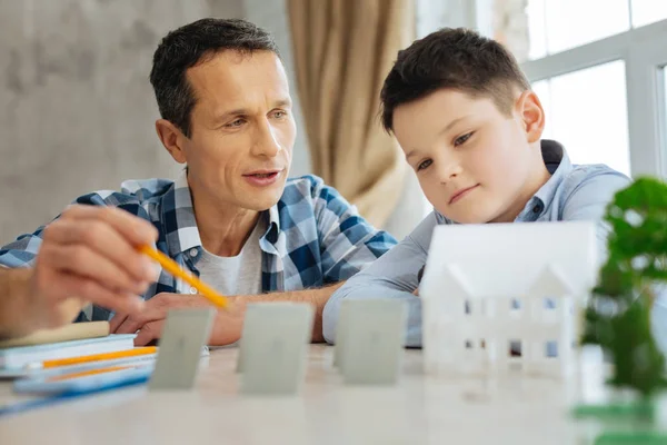 Agradable padre explicando los principios del trabajo de paneles solares — Foto de Stock