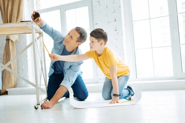 Charming father and son working on table construction — Stock Photo, Image