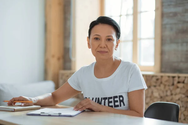 Earnest female volunteer checking list