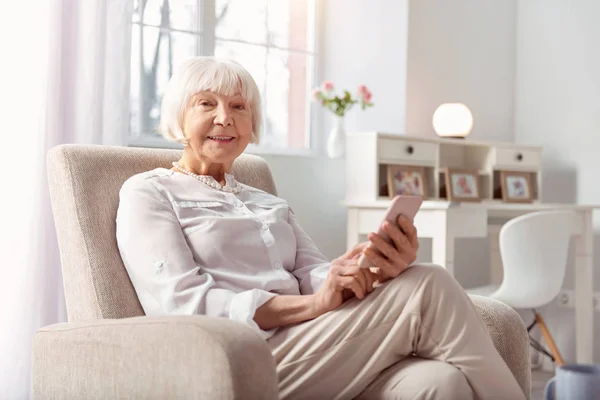 Kobieta bardzo uśmiechający się surfing Internet na jej telefon — Zdjęcie stockowe