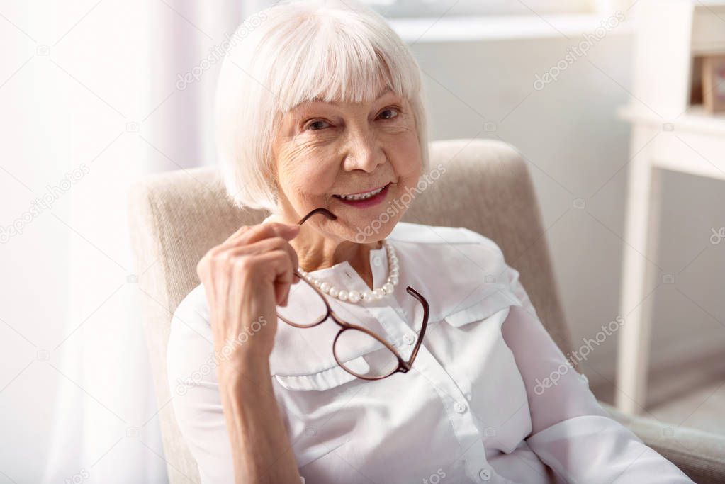 Close up of cheerful elderly woman posing without glasses