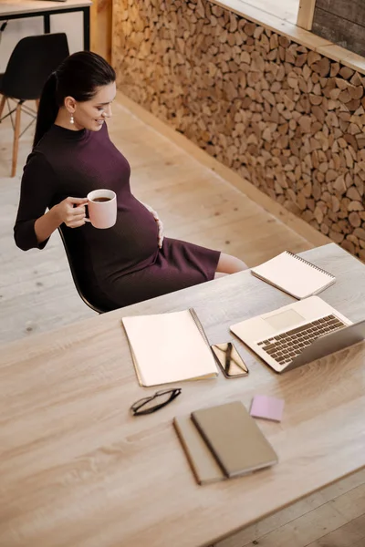 Charming pregnant businesswoman loving her baby — Stock Photo, Image