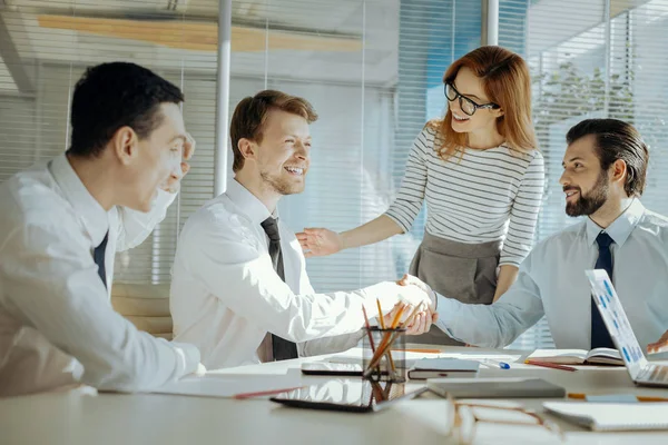 Pleasant team leader reconciling her colleagues during meeting — Stock Photo, Image