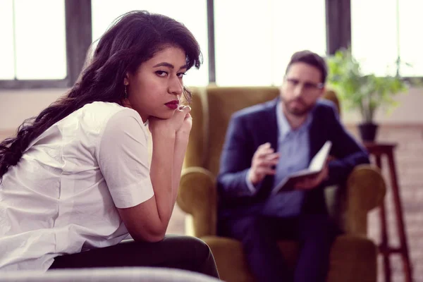 Sad unhappy young woman looking at you