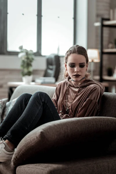 Teenager sitting on sofa feeling very depressed after school — Stock Photo, Image