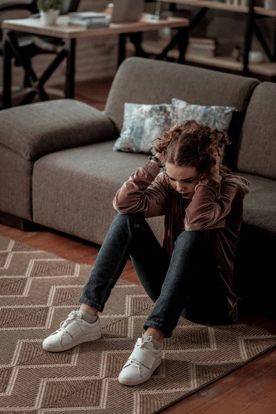 Teenage girl sitting on floor while having deep depression — Stock Photo, Image