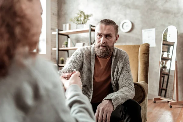 Mature and experienced therapist giving water to teenager