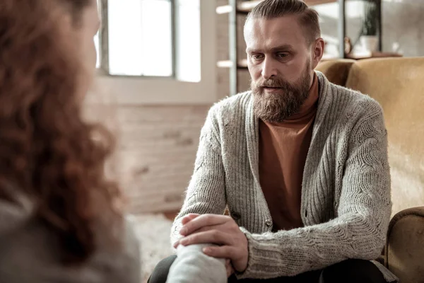 Loving bearded father calming his stressed daughter down