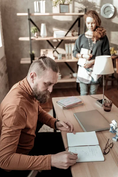 Father feeling busy making notes while daughter coming to him