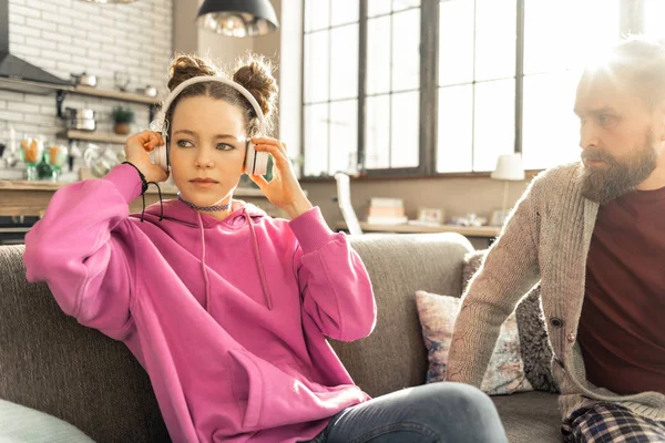 Daughter listening to music not sharing her problems with father