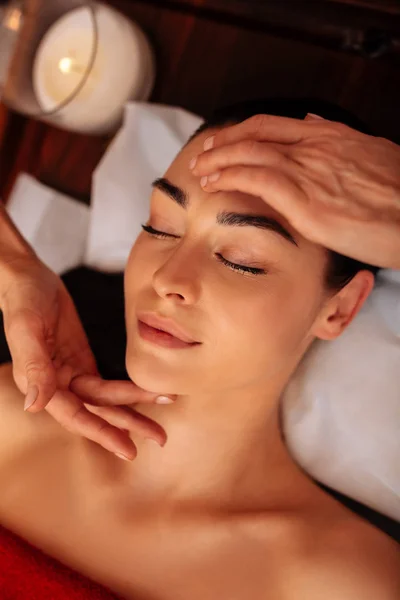 Attractive flawless female client being involved in meditative massage — Stock Photo, Image