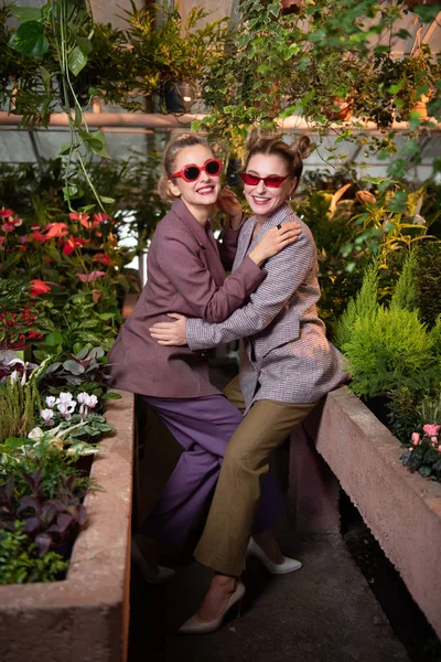 Positive cheerful women hugging each other — Stock Photo, Image