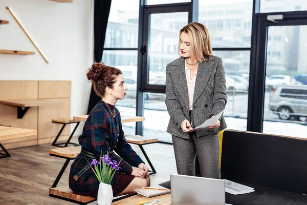 Businesswoman explaining financial issues to her young partner