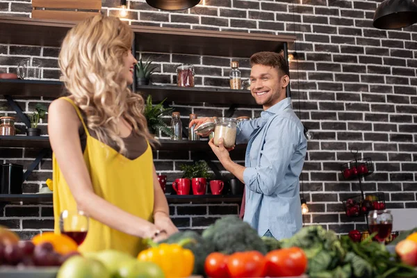 Handsome husband smiling spending time in the kitchen with woman