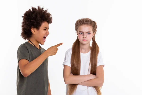 Angry long-haired girl resolutely crossing hands while boy pointing at her — Stock Photo, Image