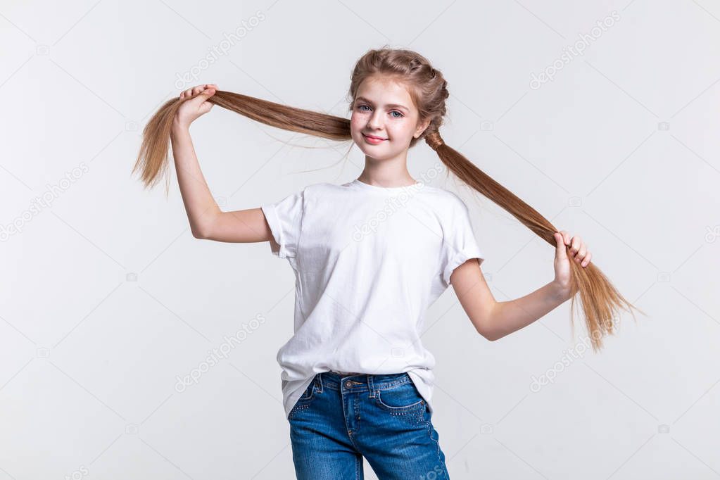 Cheerful cute girl spreading her long tails and showing their length