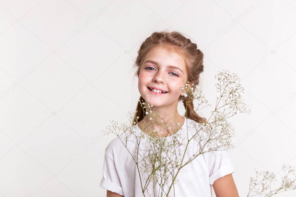 Cheerful little lady in white t-shirt actively posing